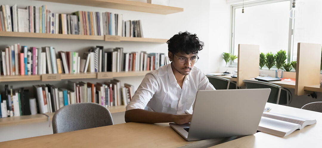 a man studying in front of a laptop